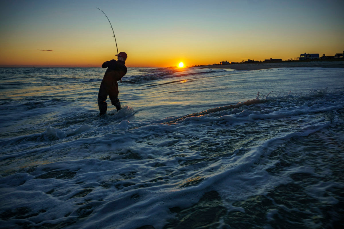 Angler fishing at sunrise