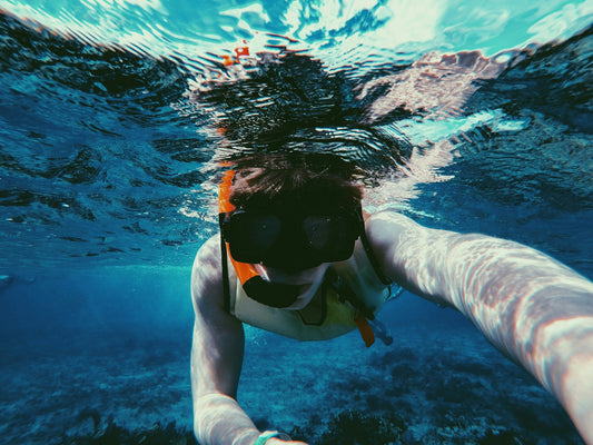 Underwater view of a snorkeler wearing a mask and snorkel