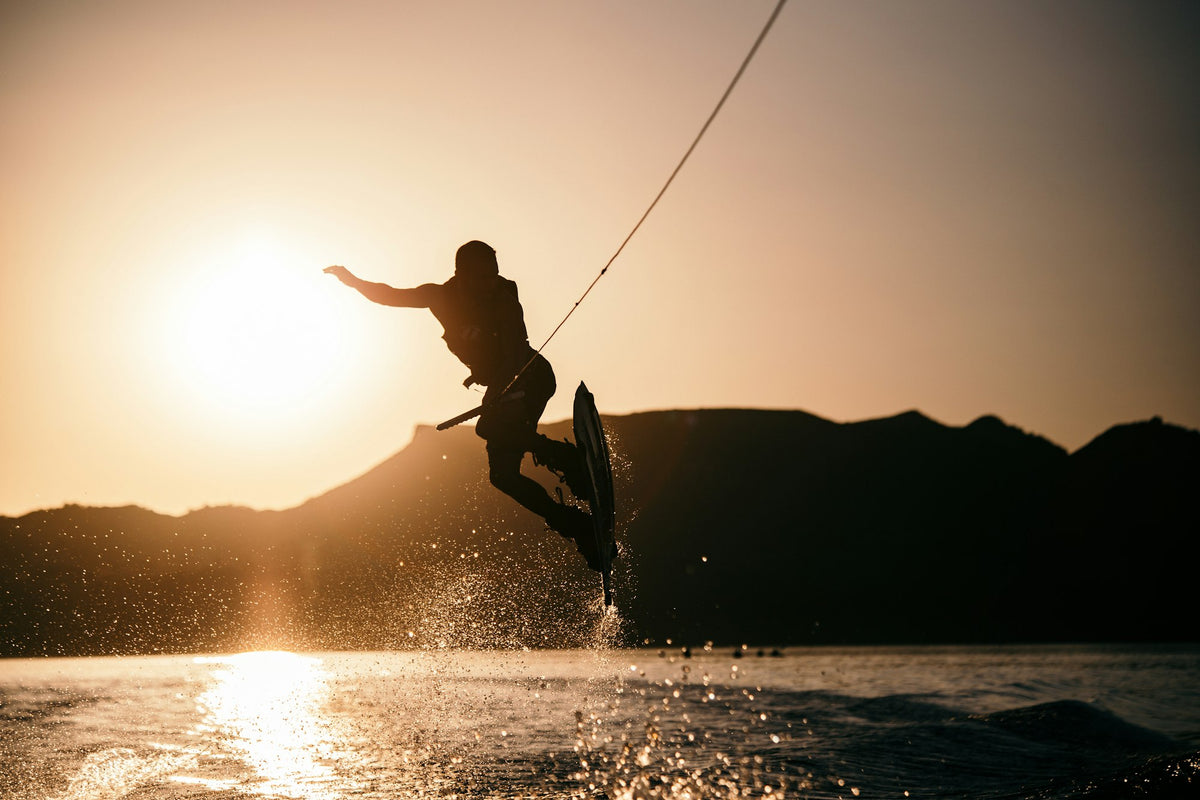 Rider wakeboarding behind a boat on open water